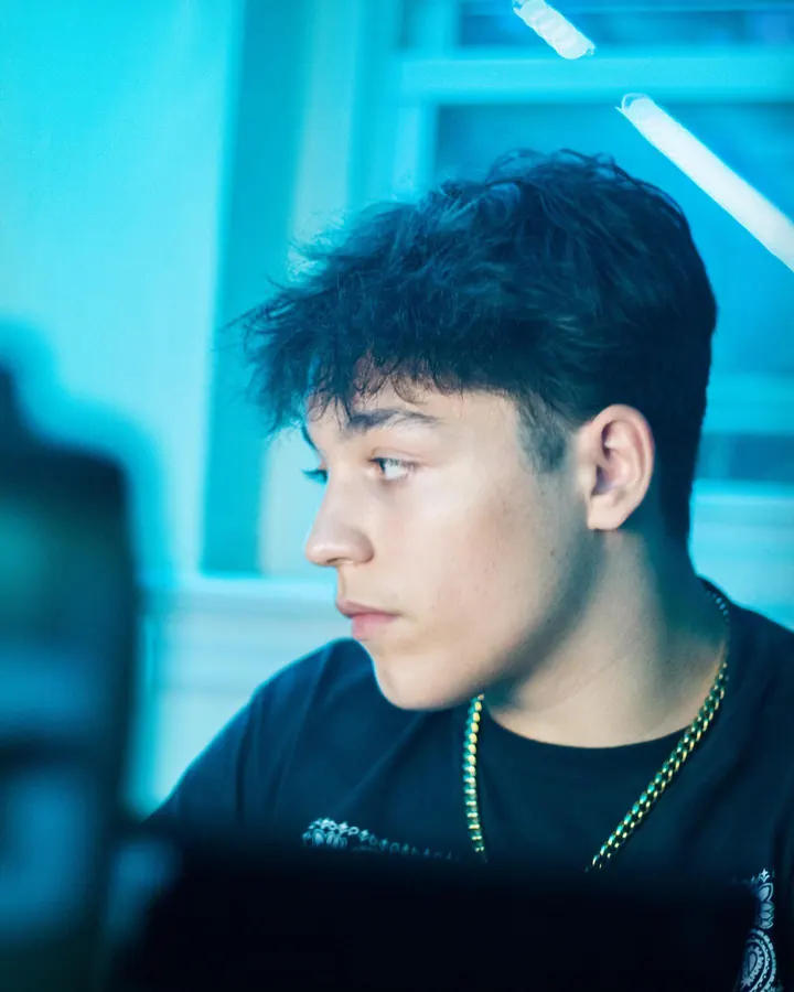 Young man looking away in blue window light