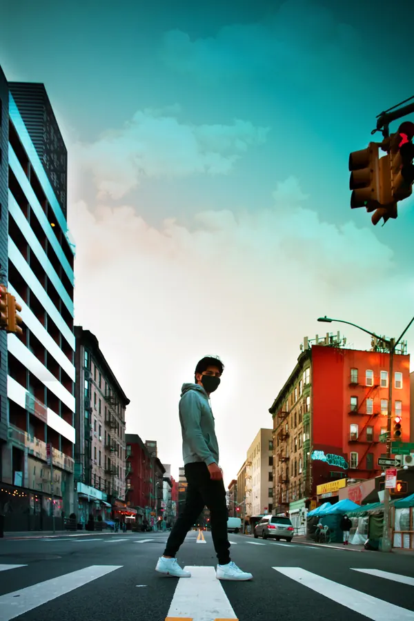 Man crossing a Chinatown street, shot from the ground