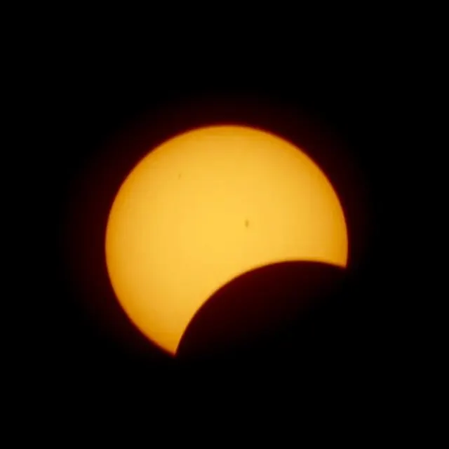 Partial solar eclipse with sunspots