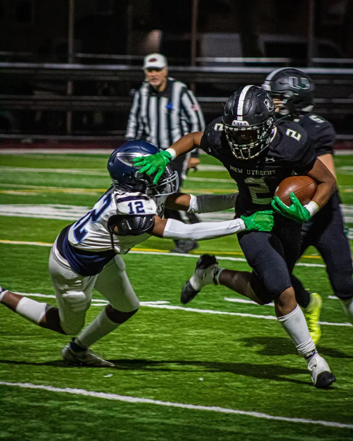 Football players colliding near the sideline