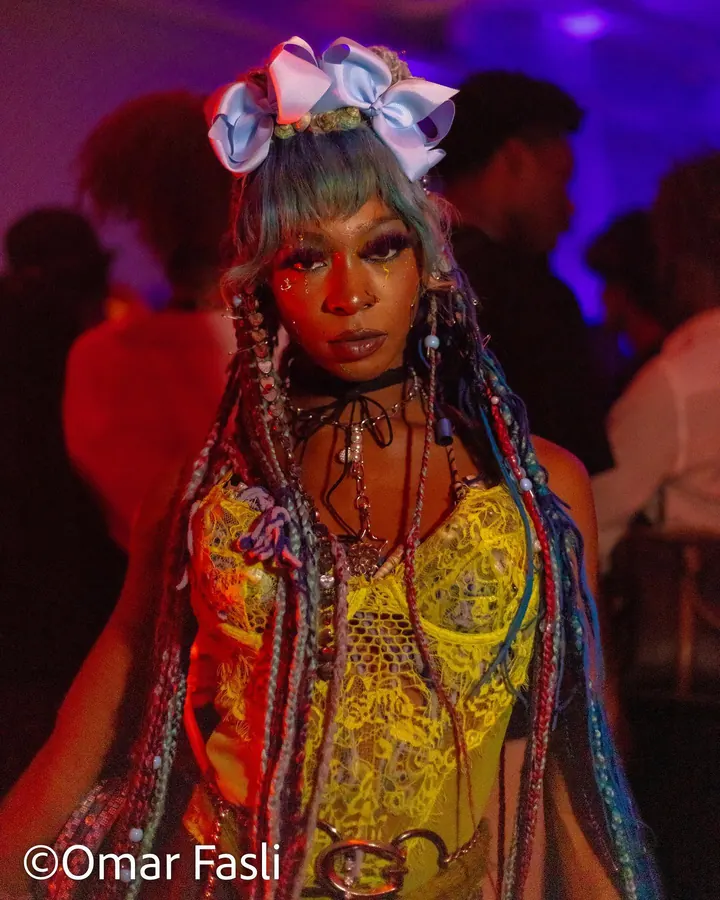 Woman with bows in her braids in the crowd at a show