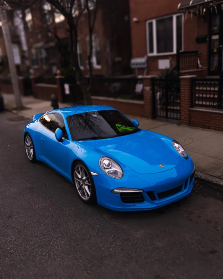 Blue Porsche 911 parked on a Brooklyn street
