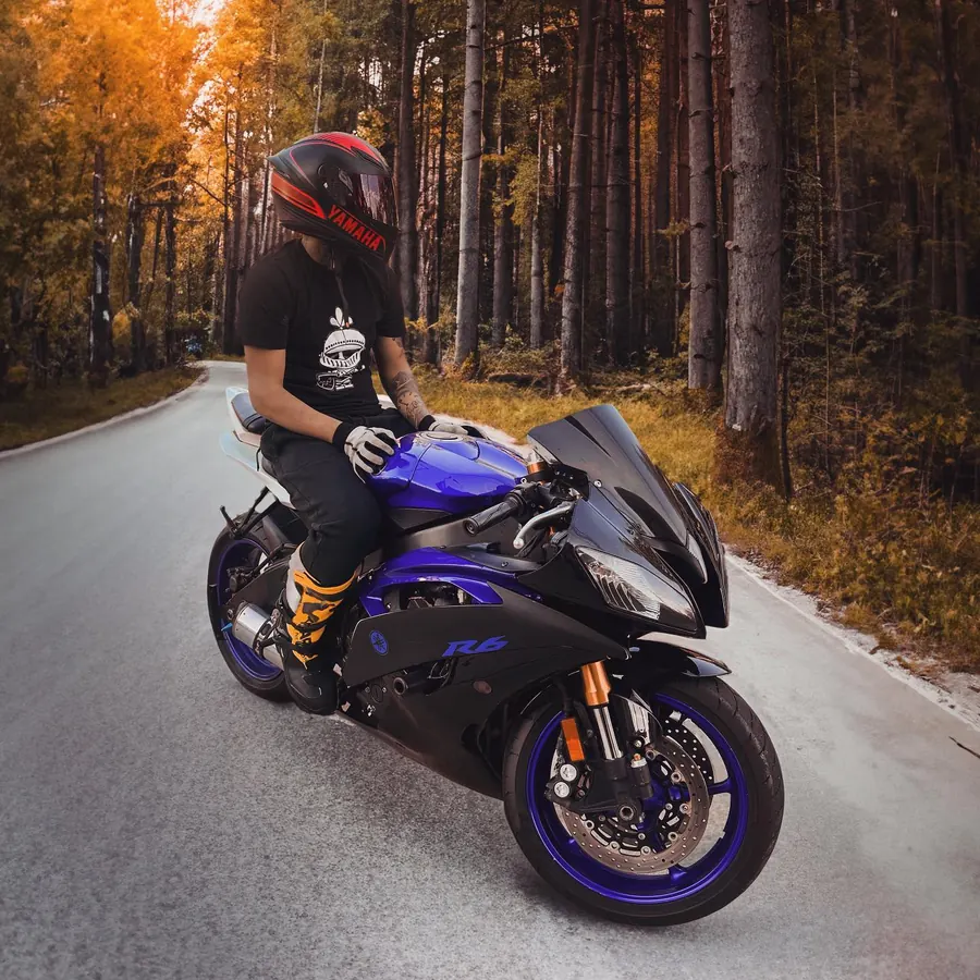 Rider on a purple Yamaha R6 on a forest road in fall