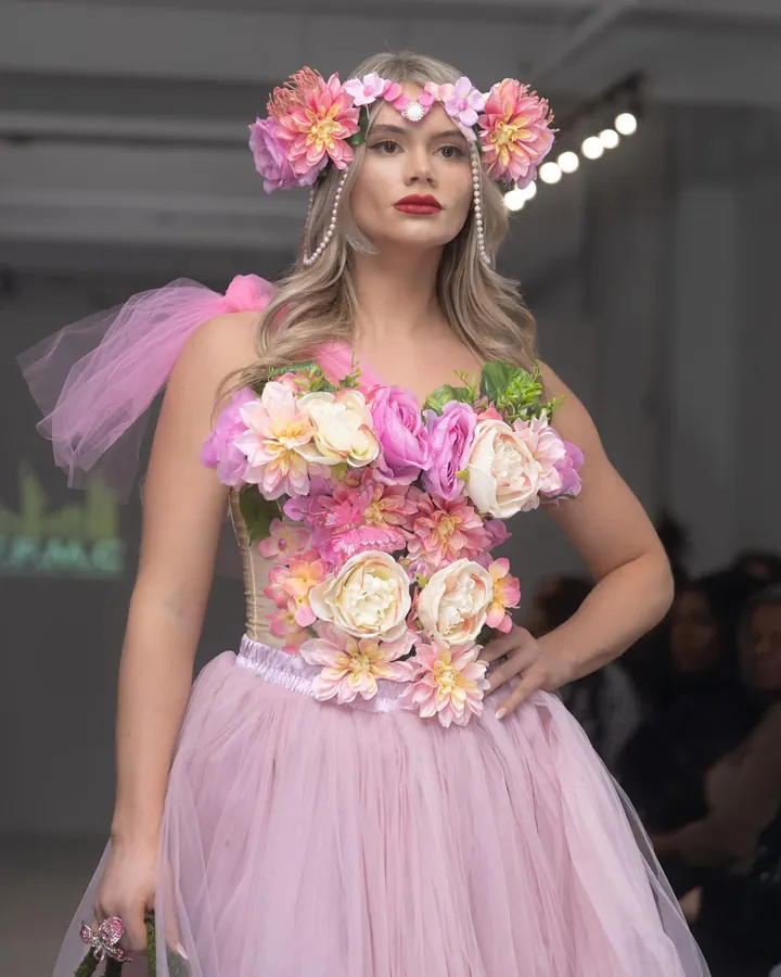 Model in a pink tulle dress with a flower bodice and flower crown