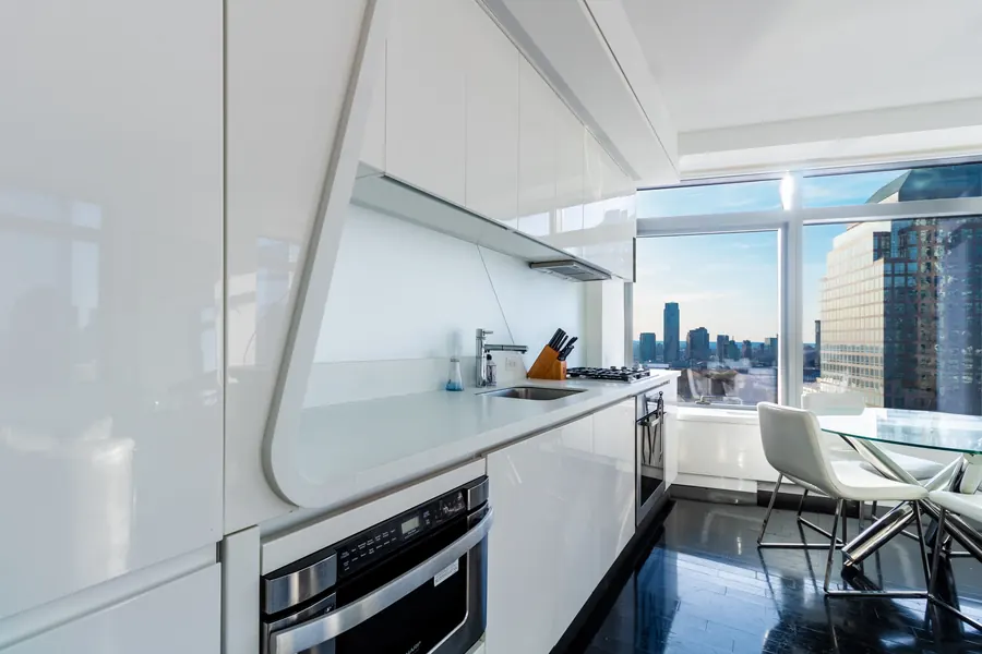White kitchen with a view of the skyline